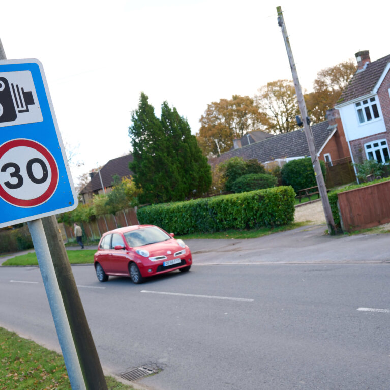car going past 30 mph speed camera sign