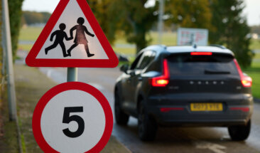 car with school sign 5mph