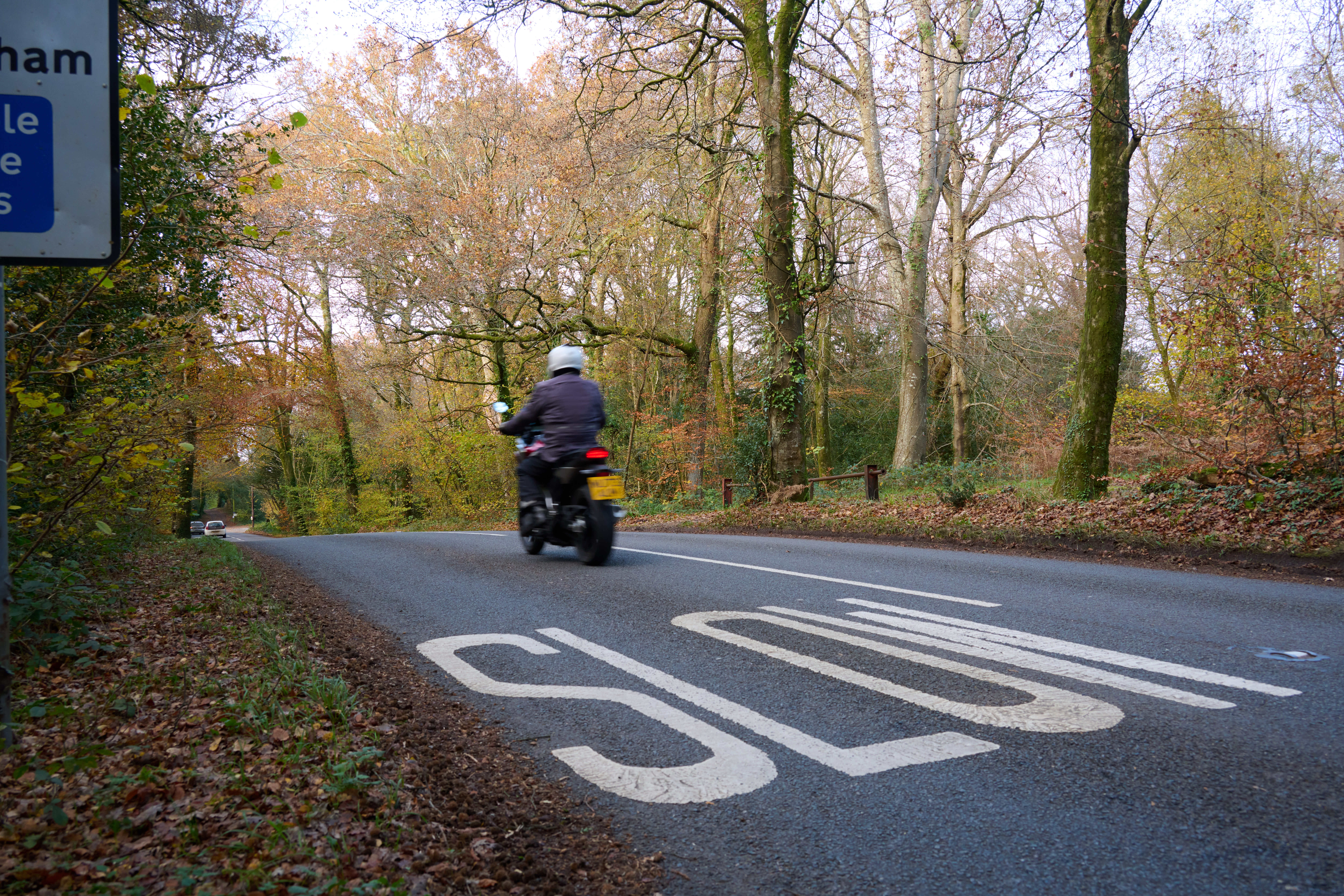 Motorbike on road with slow sign