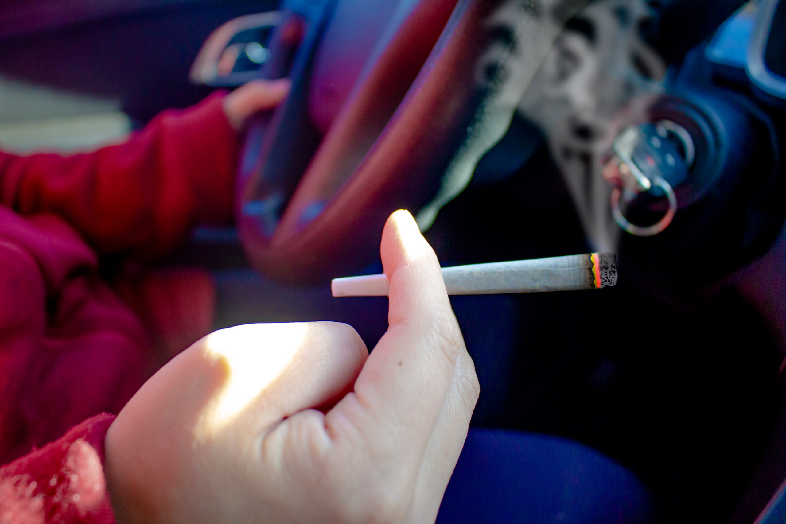 Person With Cannabis Joint Smoking And Driving