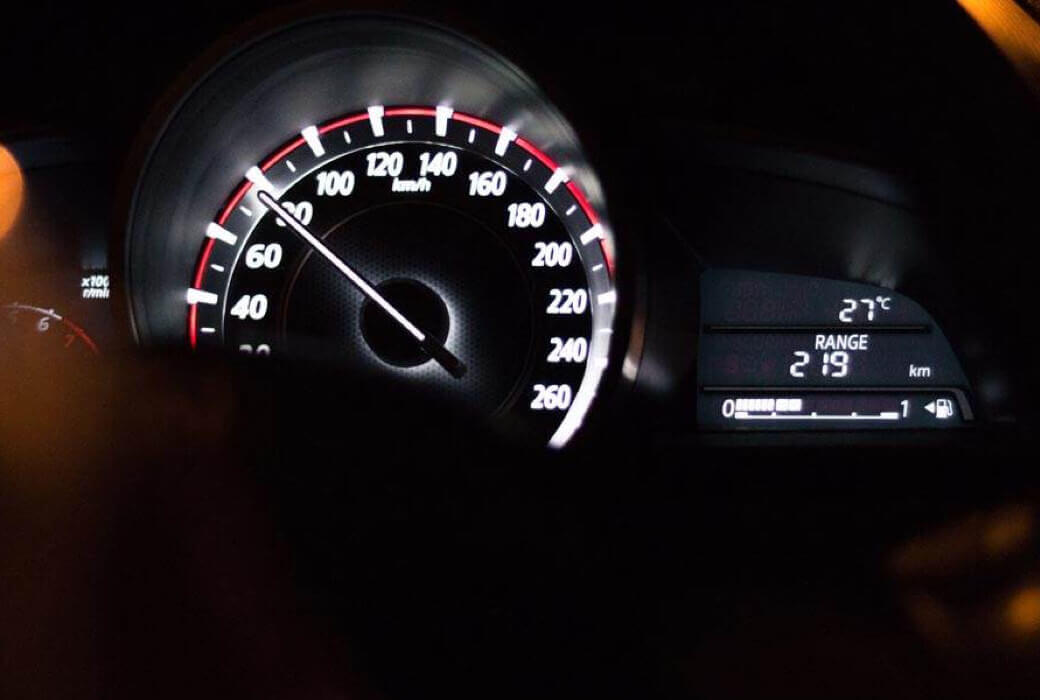 Close-up of driver holding steering wheel