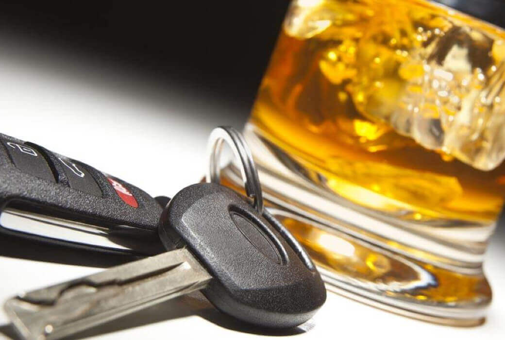 Glass of alcohol and car keys