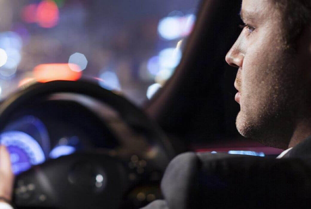 Male grey fleet driver driving at night