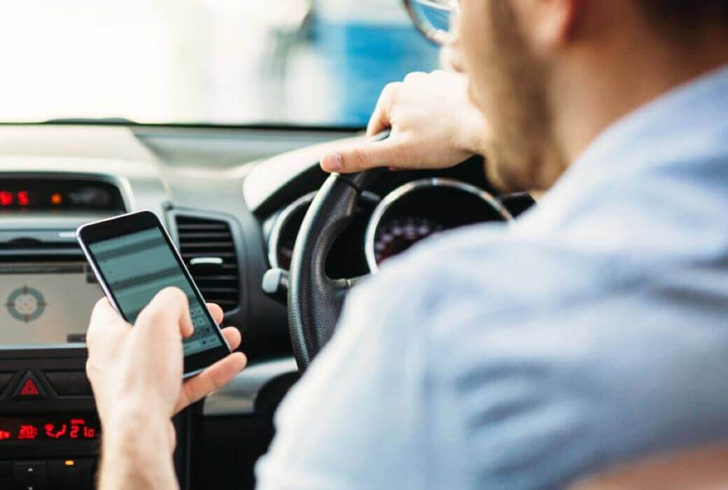 Man using mobile phone while driving