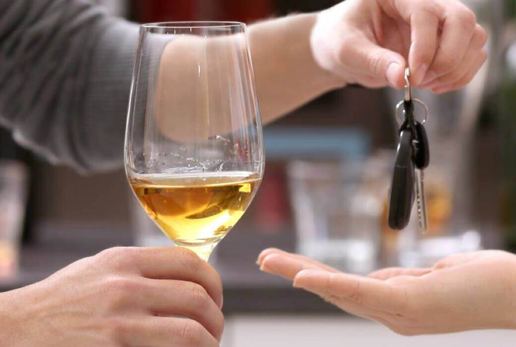 Woman driver refusing glass of wine